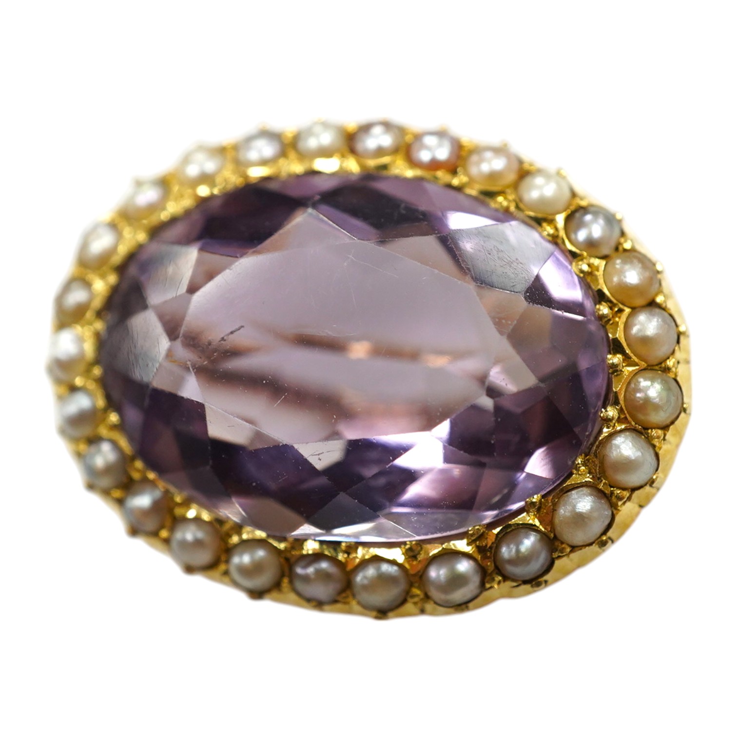 An Edwardian 15ct, amethyst and split pearl cluster set oval brooch, 23mm, gross weight 5 grams. Condition - good